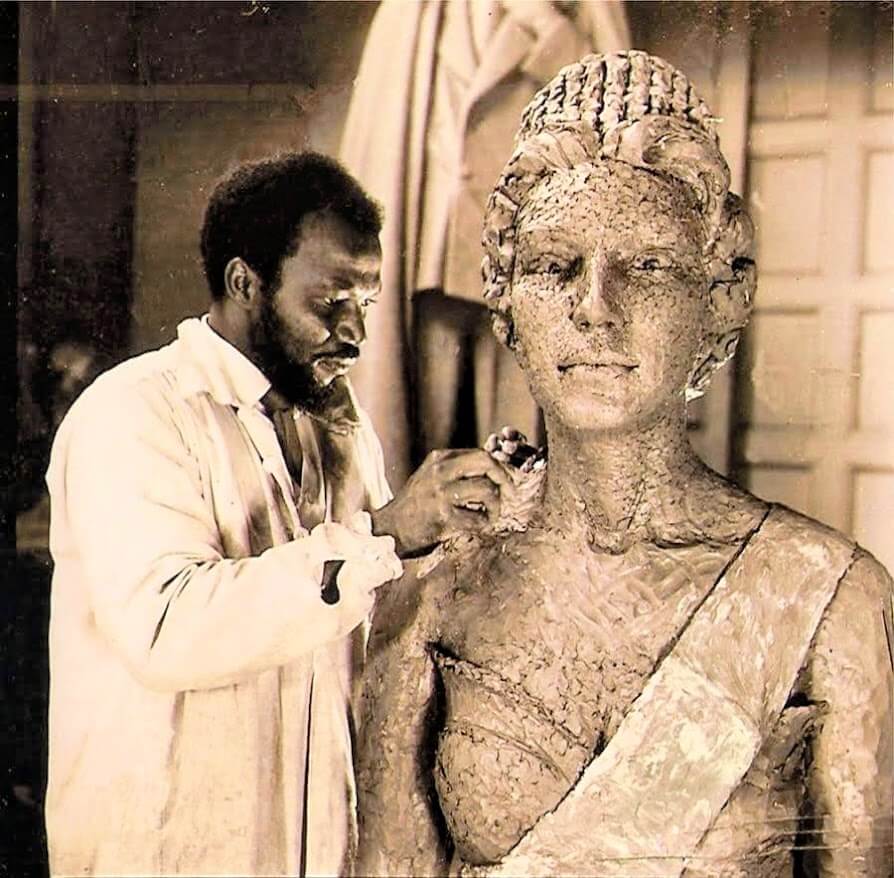 Ben Enwonwu in London studio sculpting Queen Elizabeth II bust, early 1950s.